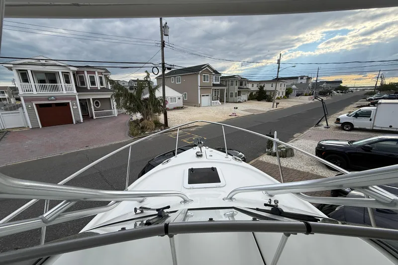 Slide: The Image of Bow view from a 2012 Sailfish 2680 WAC boat, overlooking a residential street. - 23