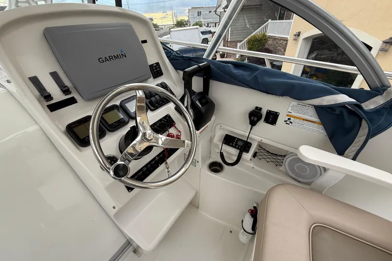 Slide: The Image of 2012 Sailfish 2680 WAC boat helm with Garmin navigation system and steering wheel. - 24