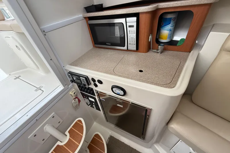 Slide: The Image of Compact galley in 2012 Sailfish 2680 WAC boat with microwave and storage. - 28