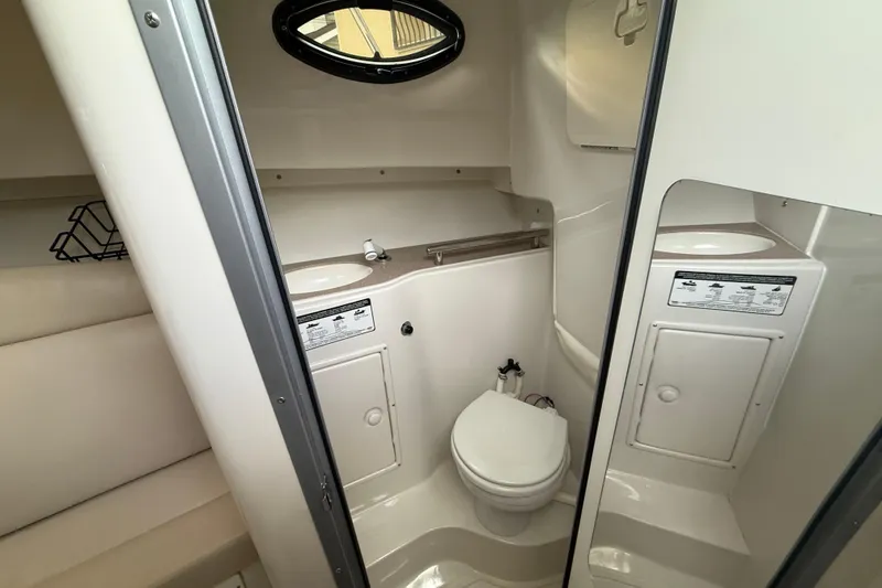 Slide: The Image of 2012 Sailfish 2680 WAC boat interior with compact bathroom and sink. - 29