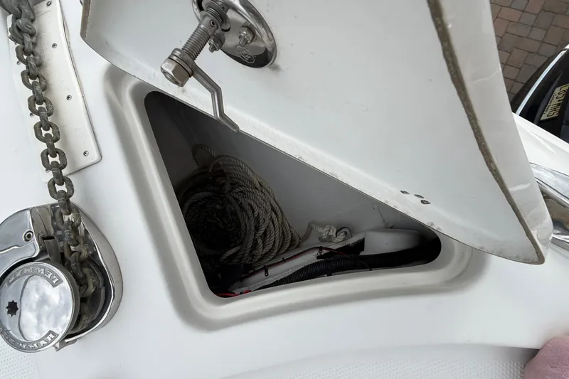 Slide: The Image of Open anchor locker on 2012 Sailfish 2680 WAC boat, showing rope and chain storage. - 32