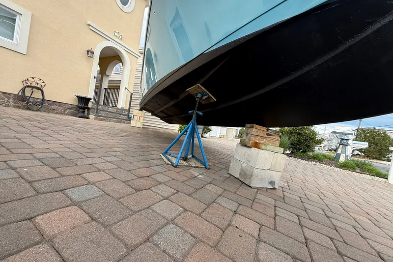 Slide: The Image of 2012 Sailfish 2680 WAC boat on blocks in driveway, side view. - 34