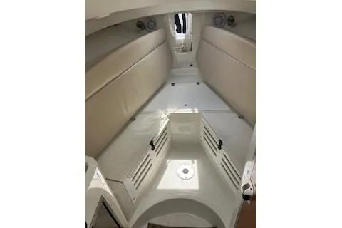 Slide: The Image of 2012 Sailfish 2680 WAC cabin interior with beige seating and white flooring. - 7