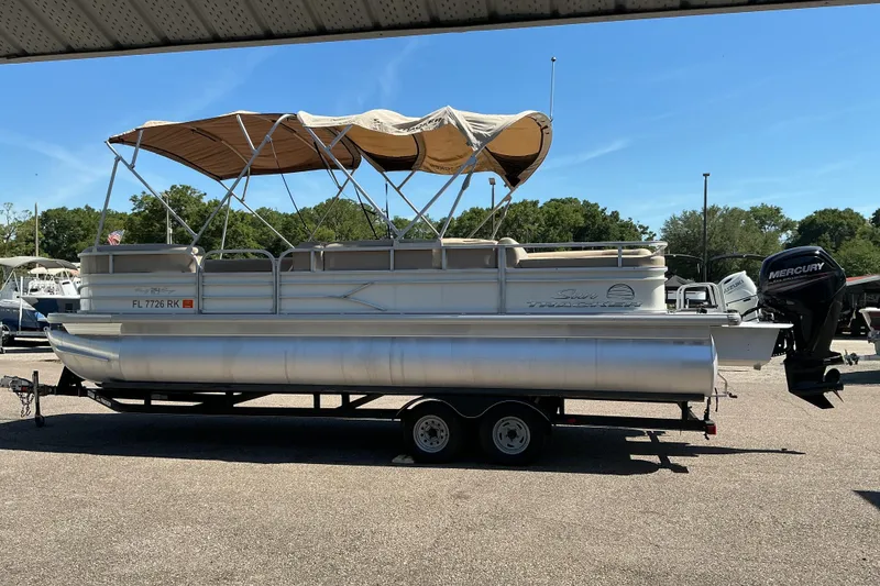 The Image of 2017 Sun Tracker Party Barge 24 DLX pontoon boat with canopy and Mercury outboard motor. - 0