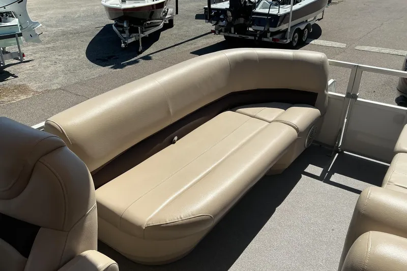 Slide: The Image of 2017 Sun Tracker Party Barge 24 DLX with beige seating, parked on a sunny day. - 10