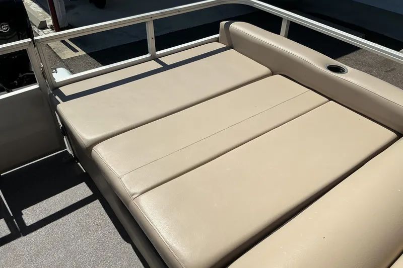 Slide: The Image of 2017 Sun Tracker Party Barge 24 DLX with beige seating and cup holder. - 11