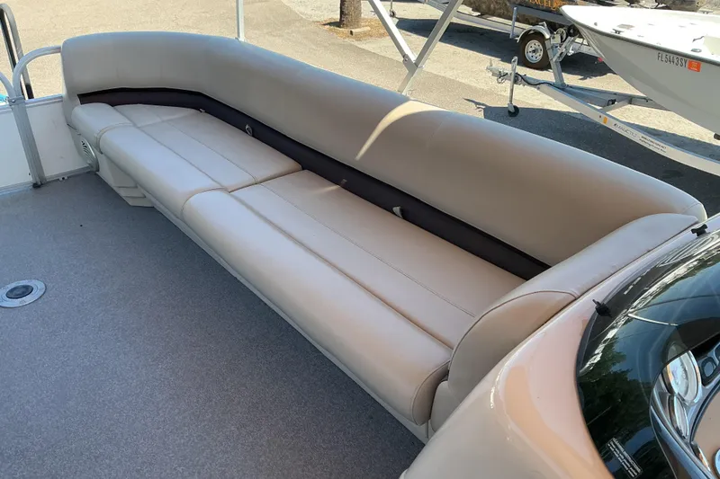 Slide: The Image of 2017 Sun Tracker Party Barge 24 DLX with spacious beige seating on deck. - 13