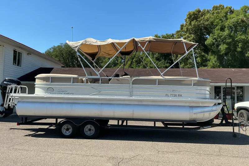Slide: The Image of 2017 Sun Tracker Party Barge 24 DLX pontoon boat on trailer, parked outdoors. - 5