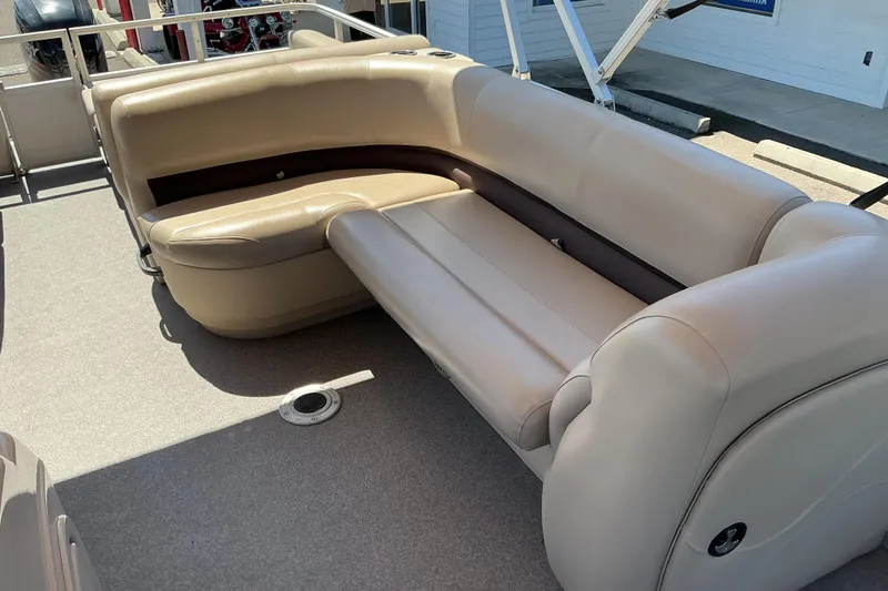 Slide: The Image of 2017 Sun Tracker Party Barge 24 DLX interior seating, featuring beige upholstery and spacious layout. - 8