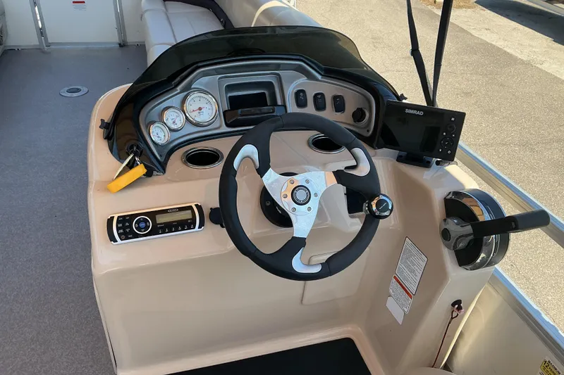 Slide: The Image of 2017 Sun Tracker Party Barge 24 DLX helm with steering wheel and control panel. - 9