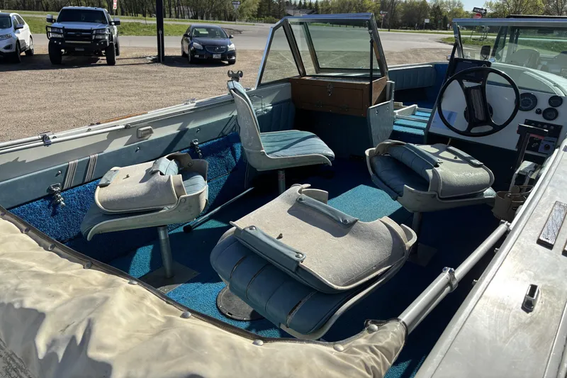 Slide: The Image of 1983 Crestliner 16 boat interior with blue carpet and swivel seats. - 7