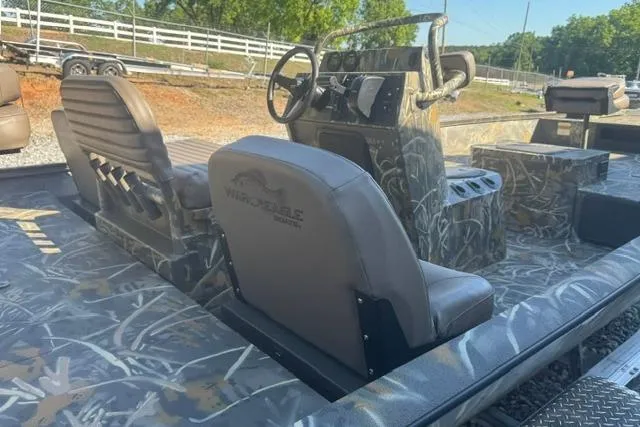 Slide: The Image of 2026 War Eagle 2170 Blackhawk boat interior with camo design and steering console. - 10