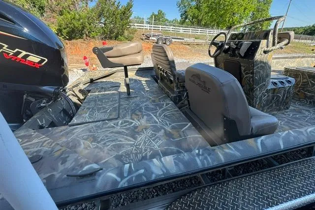Slide: The Image of 2026 War Eagle 2170 Blackhawk boat interior with camo design and seating. - 11