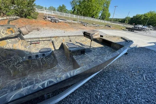 Slide: The Image of 2026 War Eagle 2170 Blackhawk boat with camouflage design on gravel lot. - 13