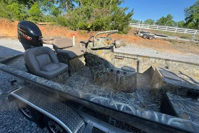 Slide: The Image of 2026 War Eagle 2170 Blackhawk boat with camo design, spacious seating, and powerful motor. - 14