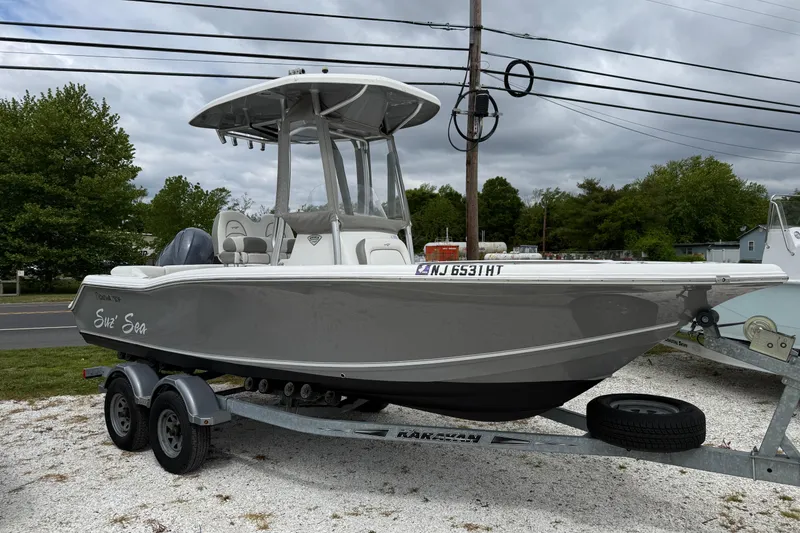 The Image of 2016 Tidewater 210 LXF boat on trailer, parked outdoors. - 1
