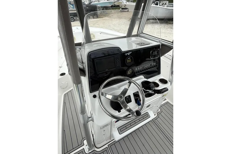 Slide: The Image of Helm of 2016 Tidewater 210 LXF boat with steering wheel and control panel. - 4