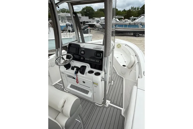 Slide: The Image of 2016 Tidewater 210 LXF boat interior with steering console and seating. - 7