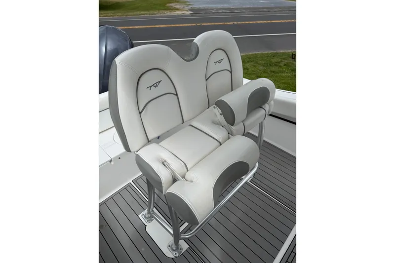 Slide: The Image of 2016 Tidewater 210 LXF boat seat with cushioned armrests and sleek design. - 9