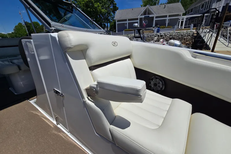 Slide: The Image of 2016 Cobalt R3 boat with white leather seating and armrest, docked near a marina. - 11
