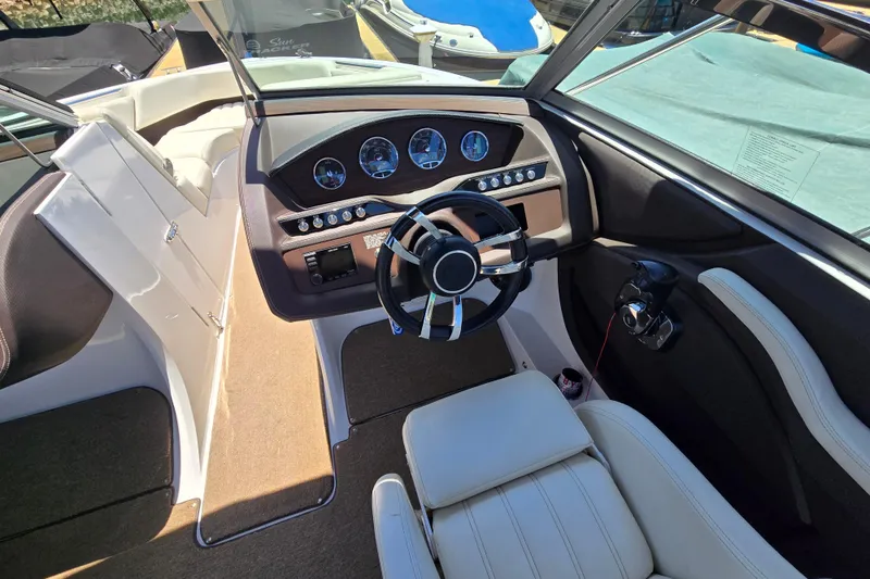Slide: The Image of Interior view of a 2016 Cobalt R3 boat cockpit with steering wheel and dashboard. - 13