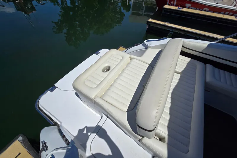 Slide: The Image of 2016 Cobalt R3 boat with white leather seating, docked by calm water. - 14