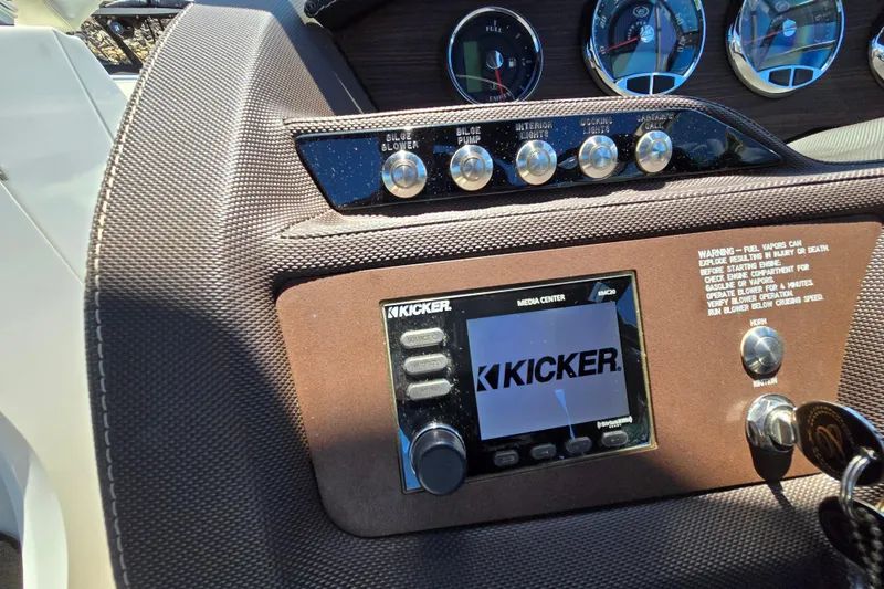 Slide: The Image of Dashboard of a 2016 Cobalt R3 boat featuring Kicker media center and control switches. - 22
