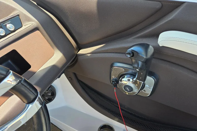 Slide: The Image of Interior of a 2016 Cobalt R3 boat showing steering wheel and control panel. - 24