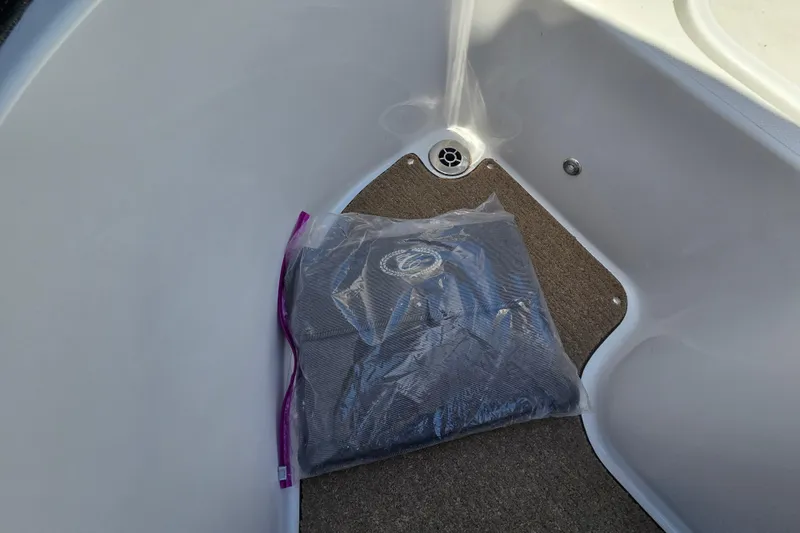 Slide: The Image of Cobalt R3 2016 boat interior with carpeted floor and packaged item. - 29