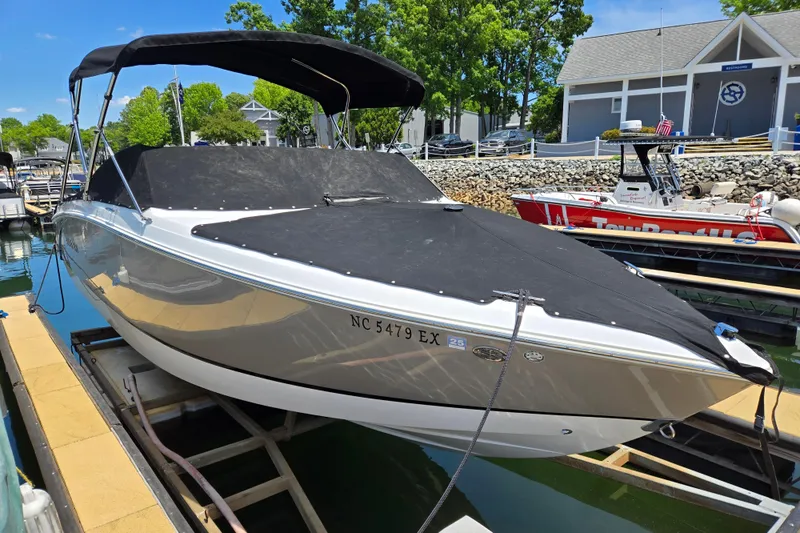 Slide: The Image of 2016 Cobalt R3 boat docked with black cover, marina background. - 3