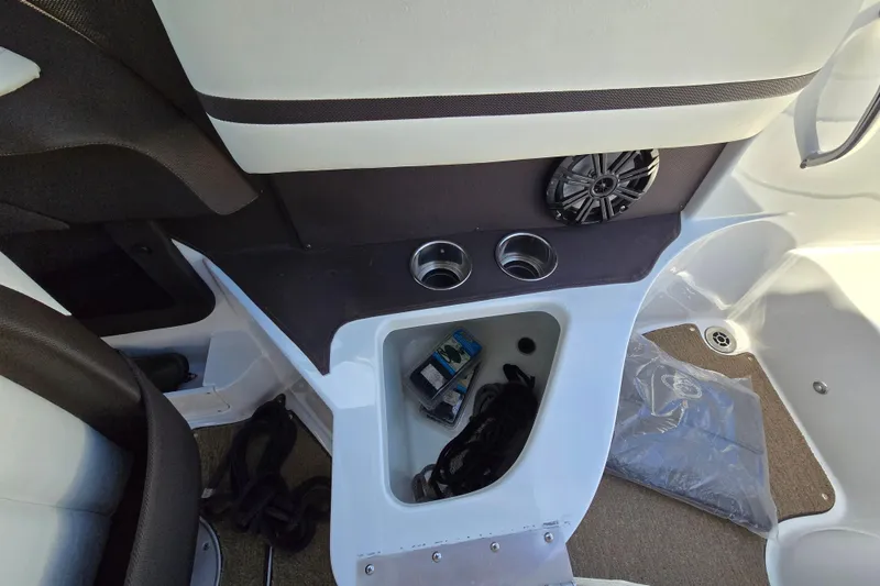 Slide: The Image of Interior of a 2016 Cobalt R3 boat featuring cup holders and storage compartment. - 30