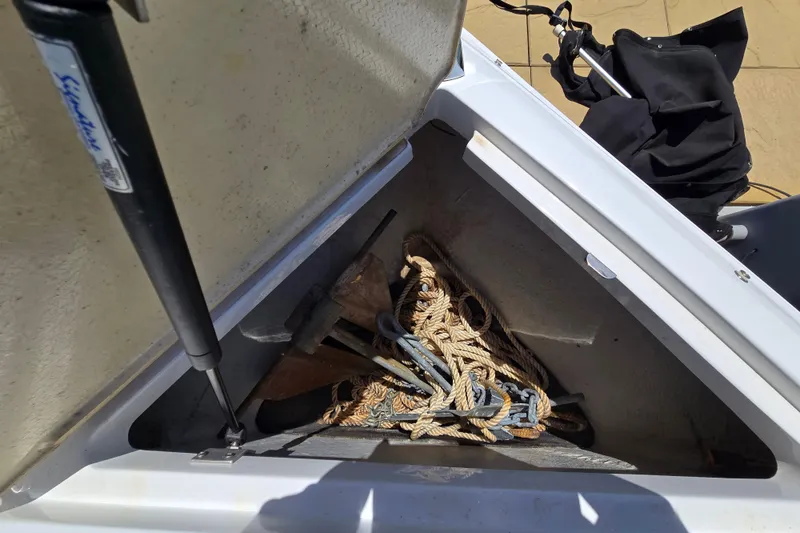 Slide: The Image of Open storage compartment on 2016 Cobalt R3 boat with ropes and anchor. - 31