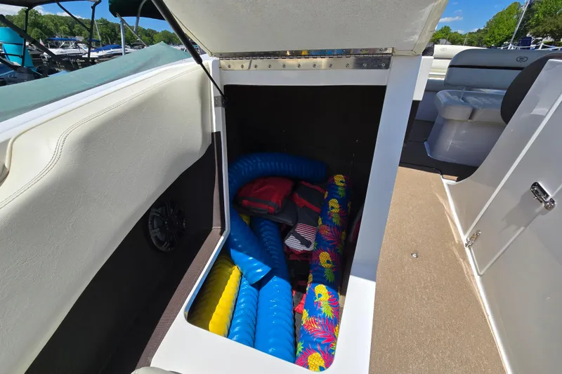 Slide: The Image of Storage compartment in a 2016 Cobalt R3 boat with colorful inflatables and life jackets. - 33