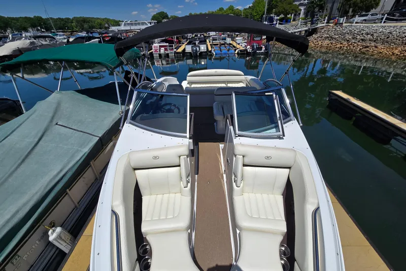 Slide: The Image of 2016 Cobalt R3 boat docked at marina, featuring sleek white seating and canopy. - 8