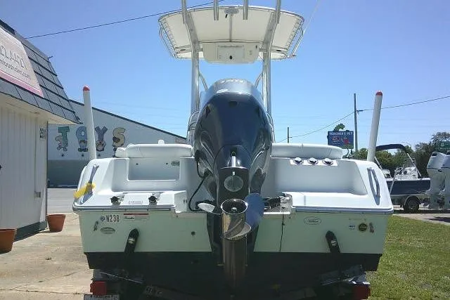 Slide: The Image of 2017 Sea Hunt Ultra 211 boat with outboard motor, parked outdoors on a sunny day. - 10