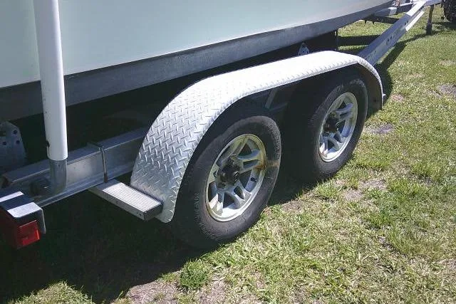 Slide: The Image of Trailer for 2017 Sea Hunt Ultra 211 boat on grass. - 12