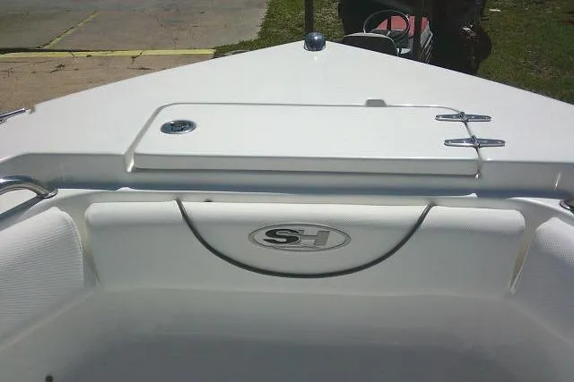 Slide: The Image of 2017 Sea Hunt Ultra 211 boat interior with storage compartment and logo. - 15