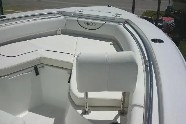 Slide: The Image of 2017 Sea Hunt Ultra 211 boat interior with white seating and stainless steel railings. - 19