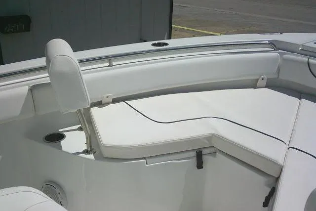 Slide: The Image of 2017 Sea Hunt Ultra 211 boat interior with white cushioned seating. - 20