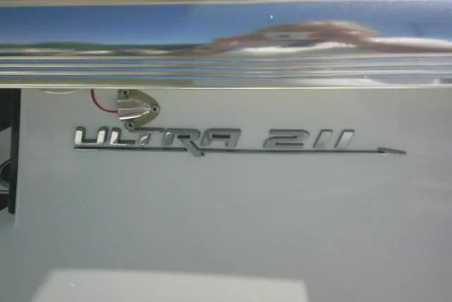 Slide: The Image of 2017 Sea Hunt Ultra 211 boat emblem on a sleek white surface. - 21