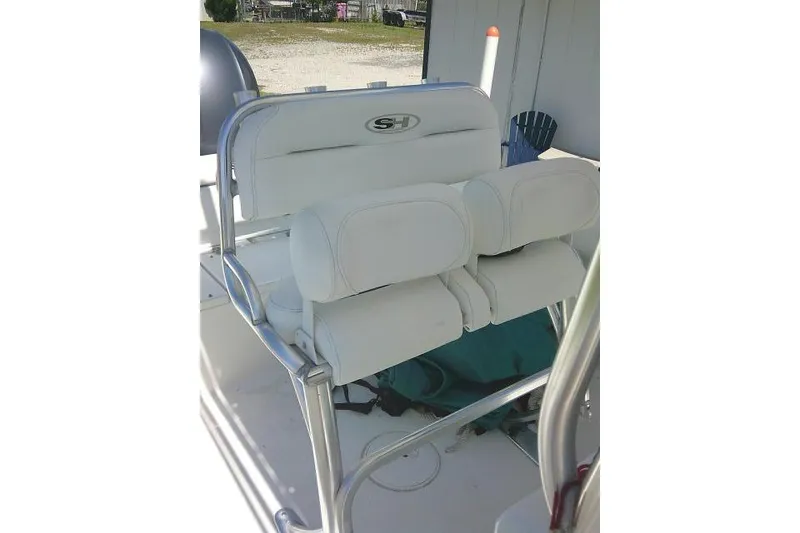 Slide: The Image of 2017 Sea Hunt Ultra 211 boat seating with white cushions and metal frame. - 22