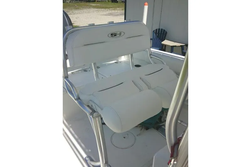 Slide: The Image of 2017 Sea Hunt Ultra 211 boat seating with white upholstery and metal frame. - 23
