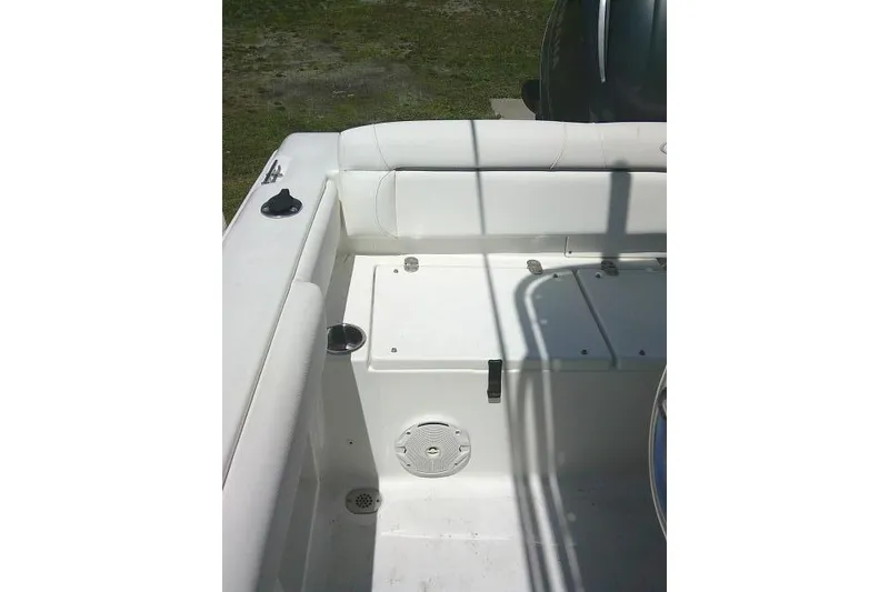 Slide: The Image of 2017 Sea Hunt Ultra 211 boat interior, featuring white seating and storage compartments. - 24