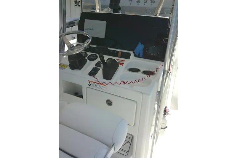 Slide: The Image of 2017 Sea Hunt Ultra 211 boat console with steering wheel and navigation equipment. - 26