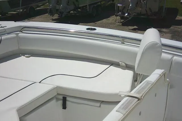 Slide: The Image of 2017 Sea Hunt Ultra 211 boat interior with white cushioned seating. - 28
