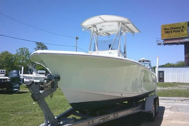 Slide: The Image of 2017 Sea Hunt Ultra 211 boat on trailer, parked outdoors under clear sky. - 3