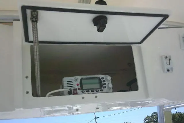 Slide: The Image of 2017 Sea Hunt Ultra 211 boat compartment with electronic device inside. - 37