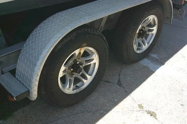 Slide: The Image of Trailer wheels of a 2017 Sea Hunt Ultra 211 boat on a concrete surface. - 7