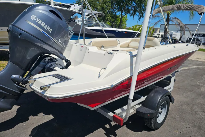 Slide: The Image of 2019 Stingray 182 SC boat with Yamaha engine on trailer, parked outdoors. - 10