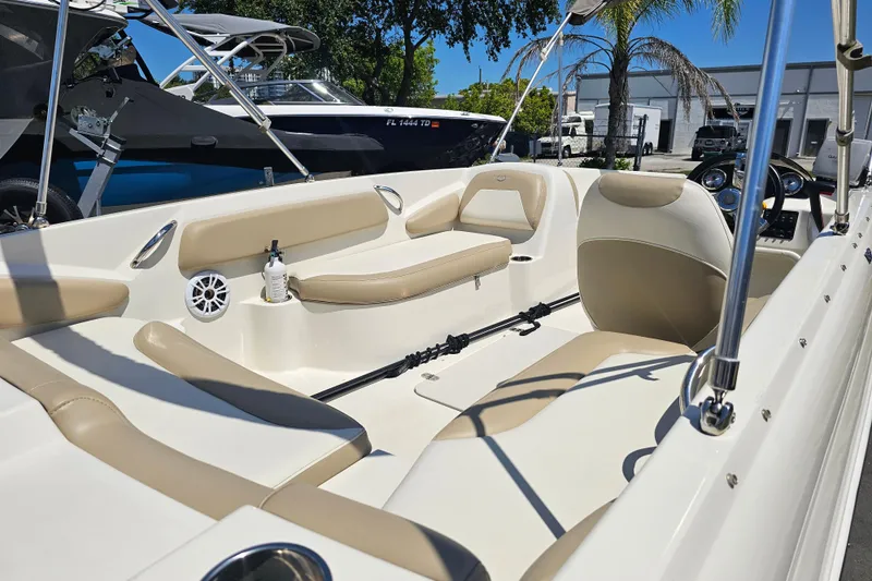 Slide: The Image of 2019 Stingray 182 SC boat interior with beige seating and modern dashboard. - 21